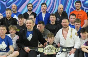 Philip Mulpeter and John Kavanagh with Conor McGregor's UFC belt