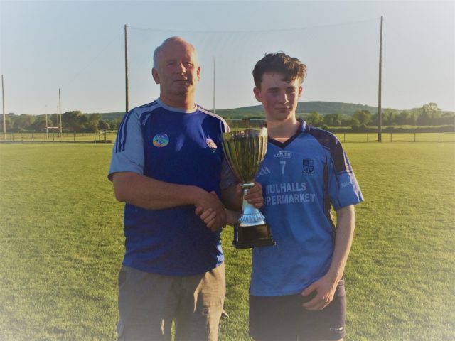 Ballyroan-Abbey Gaels captain accepts the cup from Danny Gorman