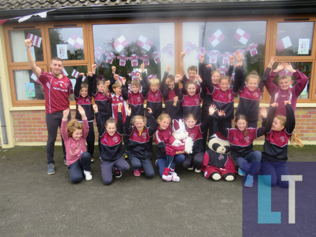 Mick Bermingham and his fourth class of Clonaghadoo NS getting ready for Kilcavan's JFC final