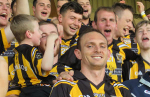 Joe Phelan and Zane Keenan receive the Bob O'Keeffe Cup from Seamus Mortimer
