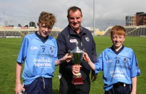Ballyroan-Abbey joint captains Shaun Fitzpatrick and Michael O'Connor receive the U-14 cup from Brian Allen. Pic: Dave Maher