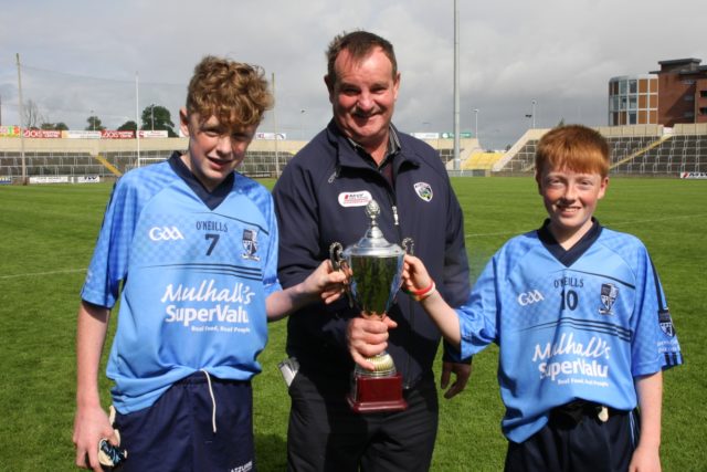 Ballyroan-Abbey joint captains Shaun Fitzpatrick and Michael O'Connor receive the U-14 cup from Brian Allen. Pic: Dave Maher