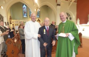 Kyrle Delaney with Fr Seán Kelly and Fr Seán Maher after being presented with his medal from Pope Francis