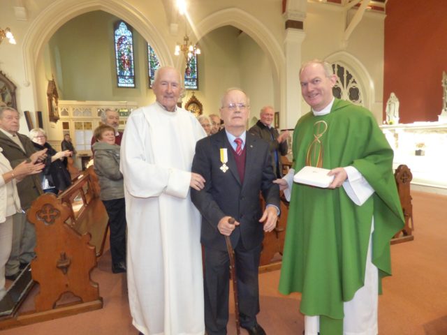 Kyrle Delaney with Fr Seán Kelly and Fr Seán Maher after being presented with his medal from Pope Francis