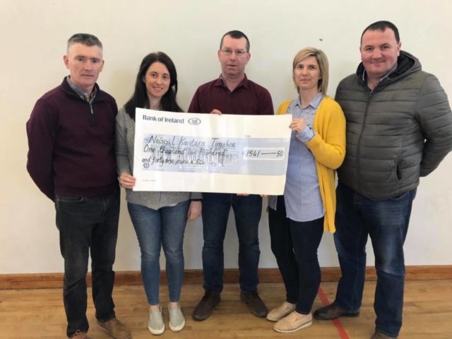 Ms Dooley and Ms Mulhare receive the cheque from Francis Devitt, committee member, Michael Miller Chairman and Liam Ramabottom Intermediate football manager