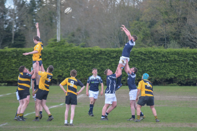 Adam Duffin goes highest lifted by Paddy Coss and Alan Maher