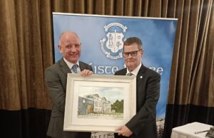 Michael Regan presents Mike Carew with a painting of Knockbeg College on behalf of the Board of Management