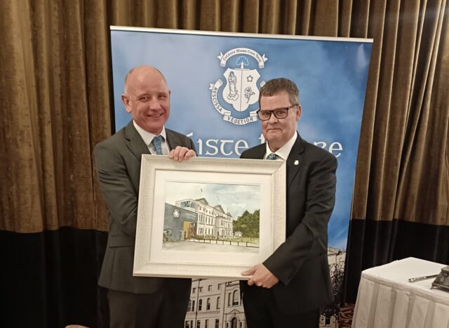 Michael Regan presents Mike Carew with a painting of Knockbeg College on behalf of the Board of Management
